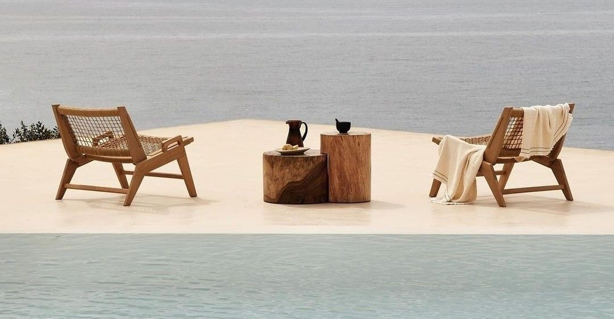 Two chairs on a terrace above the sea at the Bluevere retreat